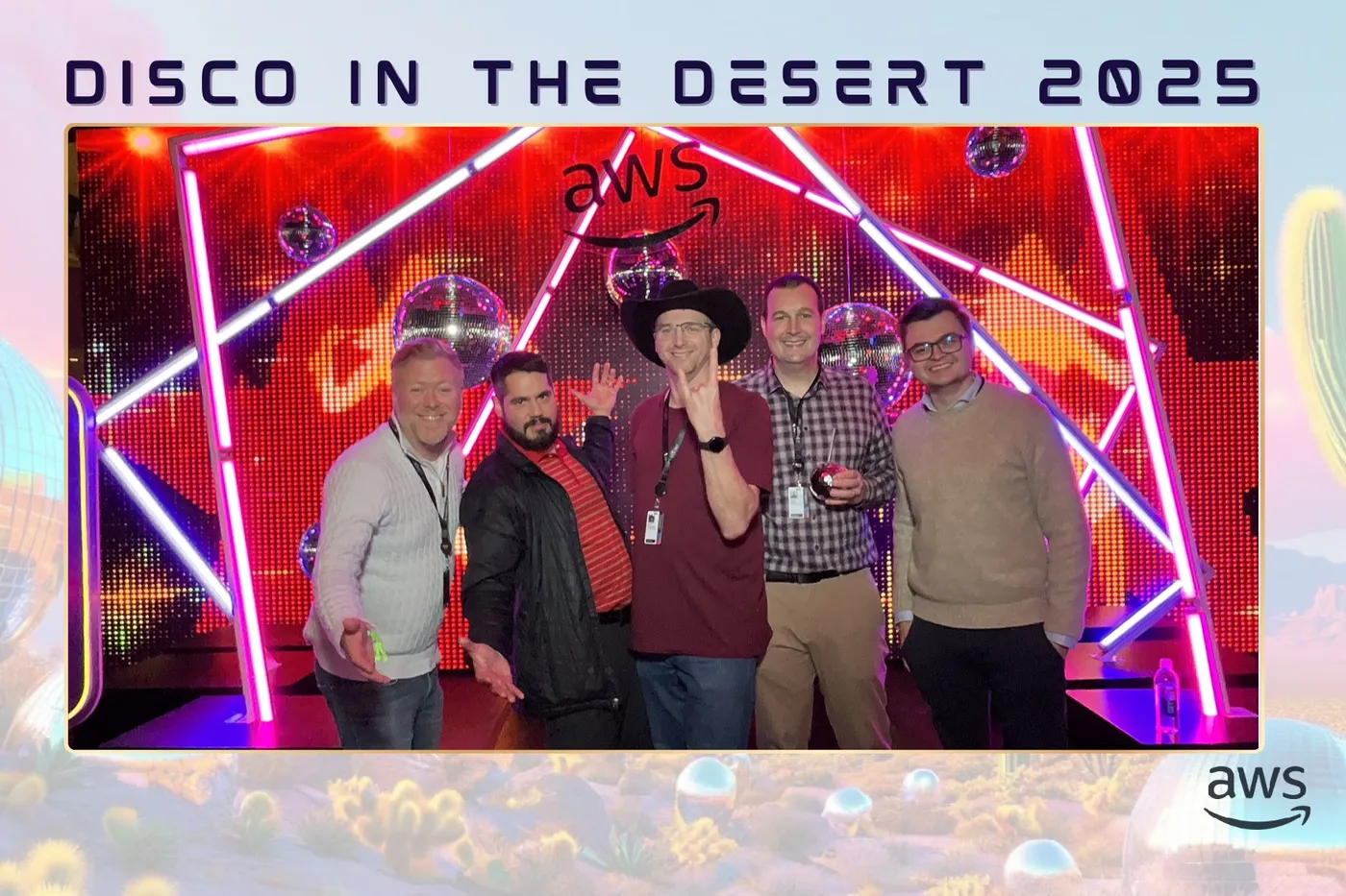 Chris in a black cowboy hat with four friends in front of a neon AWS stage at Disco in the Desert 2025